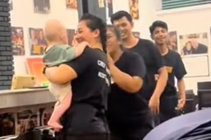 Restaurant staff watch baby so parents can eat meals in peace