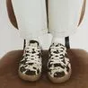 River Island just dropped a £38 pair of cow print trainers to rival the ASOS X Adidas pair
