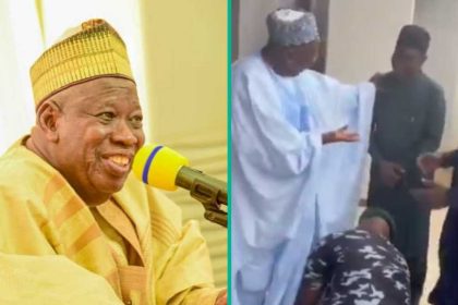 Moment police officer seen tying the shoelaces of APC national chairman, Ganduje