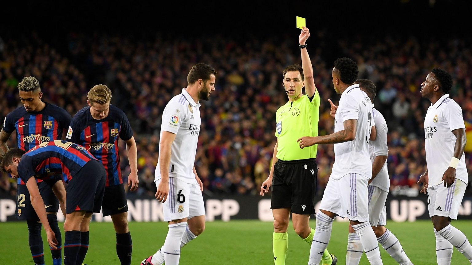 Who will referee the Clasico Copa del Rey final between Barcelona & Real Madrid and how many yellow & red cards has he dished out this season?