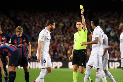 Who will referee the Clasico Copa del Rey final between Barcelona & Real Madrid and how many yellow & red cards has he dished out this season?