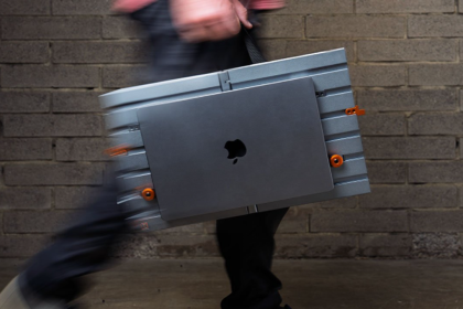 Someone designed an open portable desk with a canvas handle to carry your $10,000 Apple MacBook Pro laptop around