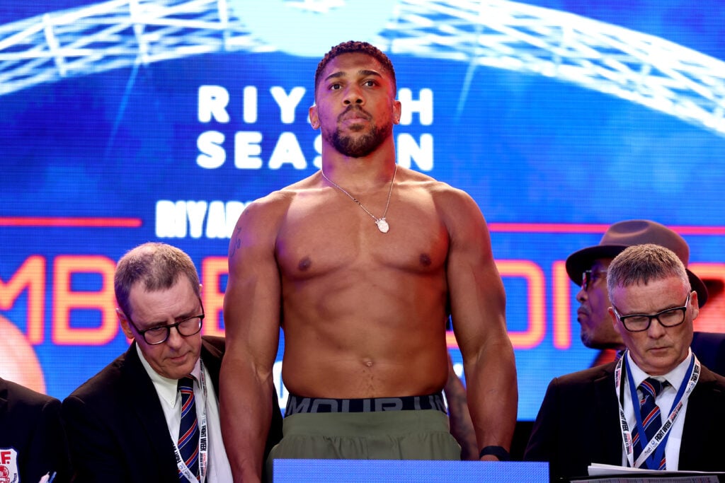 Anthony Joshua steps on the scale to reveal his weight two weeks before Jake Paul fight