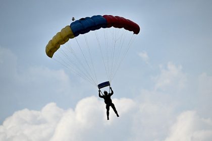 Skydiver survives after reserve parachute accidentally deploys, leaving him dangling from flying airplane